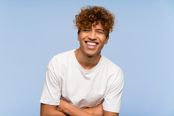 Young african american man with white shirt laughing