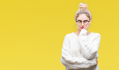 Young beautiful blonde woman wearing glasses over isolated background thinking looking tired and bored with depression problems with crossed arms.