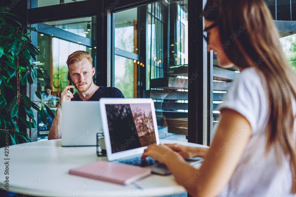 Poster caucasian hipster guy calling to operator for discussing details about internet connection on laptop