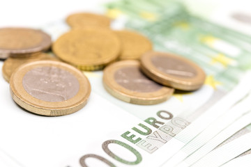 Close-up Stack of Euro banknotes and coins. 500 Euro banknotes. European currency money banknotes isolated on white backdrop. Perspective view closeup. Salary, savings, european union economic crisis 