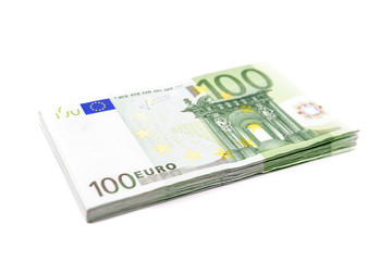 Obraz na płótnie Canvas Stack of 100 Euro banknotes. European currency money banknotes isolated on white backdrop. Perspective view closeup. Salary, savings, european union economic crisis concept.