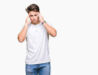 Young handsome man wearing white t-shirt over isolated background with hand on head for pain in head because stress. Suffering migraine.