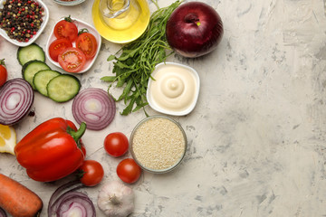 Ingredients for cooking salad. Various vegetables and spices carrots, tomatoes, onions, cucumbers, peppers and arugula on a light background. top view.