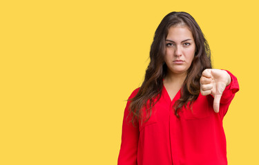 Beautiful plus size young business woman over isolated background looking unhappy and angry showing rejection and negative with thumbs down gesture. Bad expression.