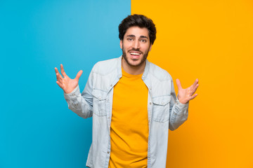 Handsome over isolated colorful background smiling a lot