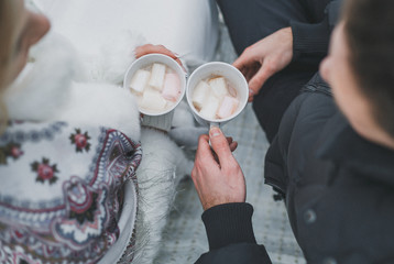 wedding day, the bride and groom drink cocoa with marshmallows, winter wedding
