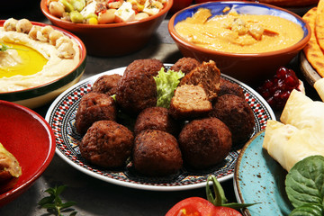 Middle eastern or arabic dishes and assorted meze, concrete rustic background. Falafel. Turkish Dessert Baklava with pistachio. Halal food. Lebanese cuisine