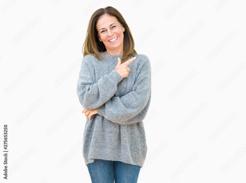 Wall mural beautiful middle age woman wearing winter sweater over isolated background cheerful with a smile of 