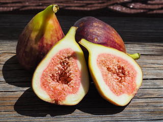 Fresh fruit figs on old boards, cut one of them in half