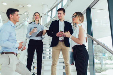 Obraz premium Group of businesspeople using a digital tablet together in office building