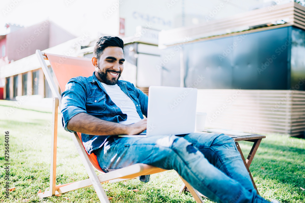 Poster happy man smiling while reading received email message from friend searching text content for resend