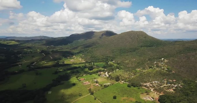 Aerial pan across a green valley near Sao Thome das Letras in Brazil