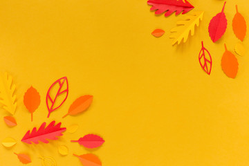 autumn leaves in the corner on an orange background, handmade of paper