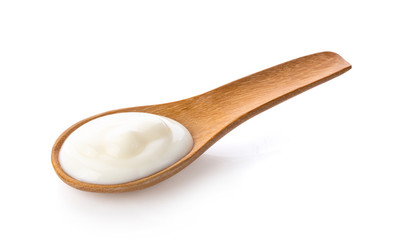 yogurt in wood spoon  isolated on white background from top view