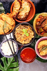 Assorted Chinese food set. Chinese noodles, fried rice, peking duck, dim sum, spring rolls. Famous Chinese cuisine dishes on table. Chinese restaurant
