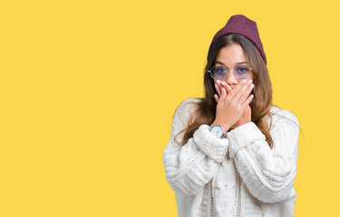 Young beautiful brunette hipster woman wearing sunglasses over isolated background shocked covering mouth with hands for mistake. Secret concept.