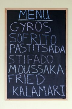 Menu on a blackboard, Greek dishes, gyros, Sofrito, Pastitsada, stifado, moussaka and fried calamari, Paleokastrista, island Corfu, Ionian Islands, Greece, Europe