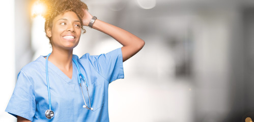 Young african american doctor woman over isolated background Smiling confident touching hair with hand up gesture, posing attractive