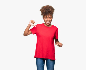 Beautiful young african american woman over isolated background looking confident with smile on...