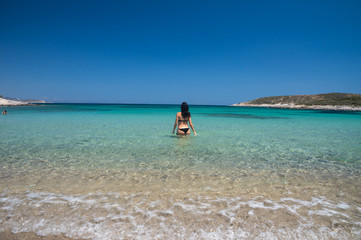 Fototapeta na wymiar Beautiful woman enjoyin in the amazing bay and beach on Antiparos Island in Cyclades, greece