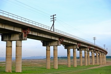 The railway across the reservoir at Pa Sak Jolasid Dam, Lop Buri, Thailand.