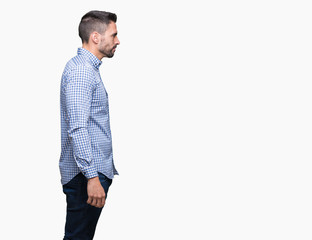 Fototapeta premium Young handsome man over isolated background looking to side, relax profile pose with natural face with confident smile.