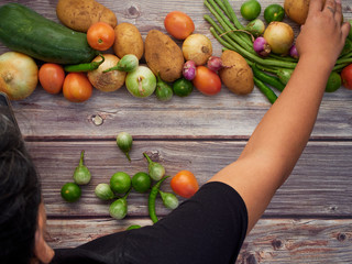Fresh local vegetables in Asia on a wooden table