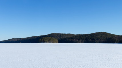 Winter landscape with lake and ice. National park Isojarvi in Finland