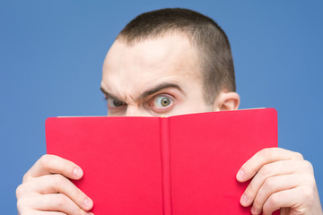 Man interestedly reads the book, close up, background, copy space, for advertising, slogan, front view