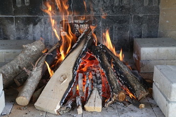 Fire, flame and hot firewood for grilling