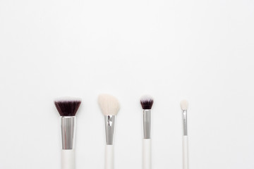 Set of makeup brushes, white background, copy space, advertising, slogan, text, top view