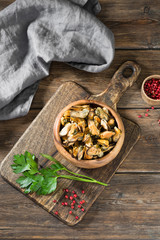 Mussel meat on a wooden Board on a wooden table. Rustic style
