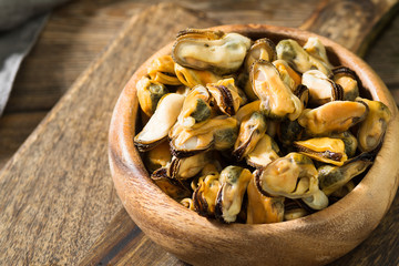 Mussel meat on a wooden Board on a wooden table. Rustic style