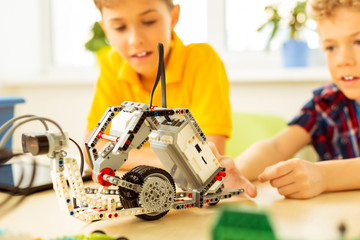 Close up of a robot being constructed by children