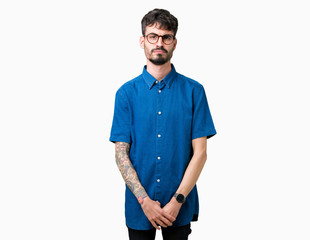 Fototapeta premium Young handsome man wearing glasses over isolated background depressed and worry for distress, crying angry and afraid. Sad expression.