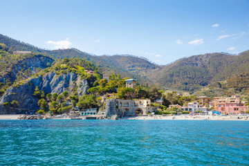 Liguria, Italy coastline of Riviera with colorful houses on sunny warm day. Monterosso al Mare, Vernazza, Corniglia, Manarola and Riomaggiore, Cinque Terre National Park UNESCO World Heritage