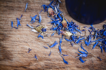 Blue cup with flowered tea on a wooden background. Breakfast, health, herbal therapy, healthy food. Concept and composition