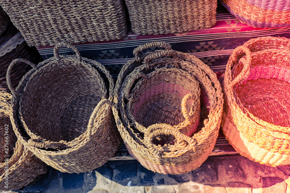 Wall mural Empty wicker baskets for sale in a market place