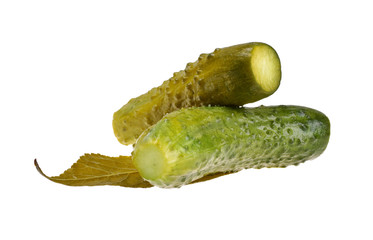 Appetizing salted cucumbers on a sheet of horseradish on a neutral white background close-up