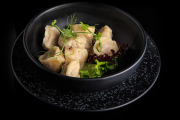 steamed meat dumplings served with salad in deep bowl