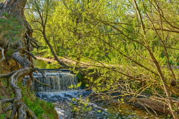 Waterfall on the river Sablinka in the village of Ulyanovsk, Leningrad region.