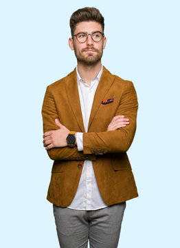 Young handsome business man wearing glasses smiling looking side and staring away thinking.