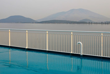 ferry boat railings and the coast of Albania in the background