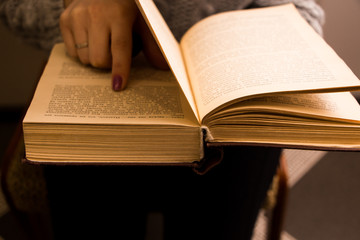 hand of a woman on old book