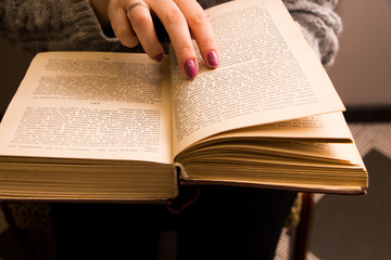 Fototapeta premium hand of a woman on old book