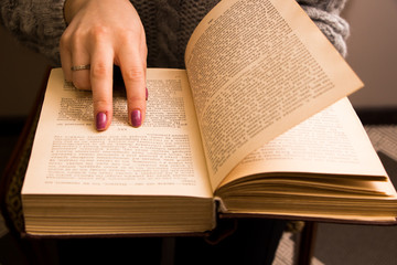 hand of a woman on old book