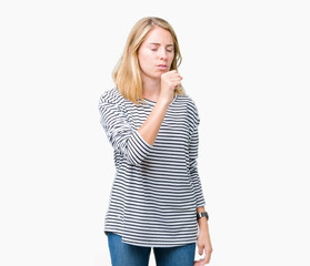 Beautiful young woman wearing stripes sweater over isolated background feeling unwell and coughing...