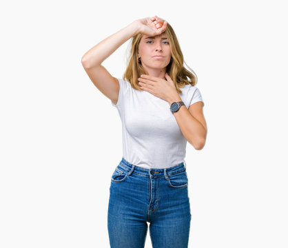 Beautiful young woman wearing casual white t-shirt over isolated background Touching forehead for illness and fever, flu and cold, virus sick