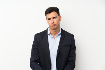 Handsome man over isolated white wall sad