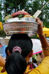 Balinese woman holding offering on the head during ceremony in Bali-Indonesia